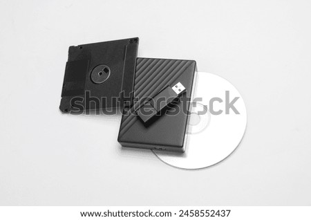 CD disk with floppy disk, USB flash drive and external hard drive on a white background. Digital information media.