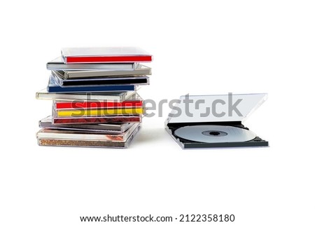 CD in an open box and a stack of discs on a white background