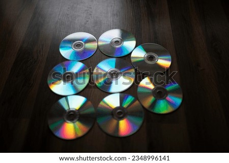 cd plates splitting light, diffraction. group of plates on the floor.