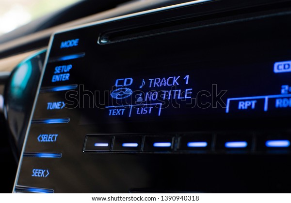Cd player text on multimedia display and push button\
in a car.