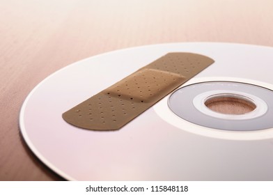 CD With Software Patch On A Wooden Backgound