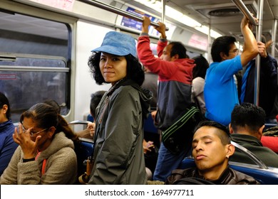 CDMX, Mexico City, Mexico - October 2019 : An Asian Female Tourist Standing In A Crowded Subway Car In CDMX, Mexico City.