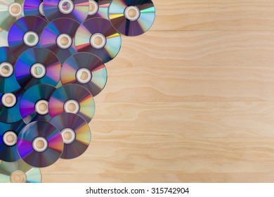 Cds And Dvds On Wooden Background