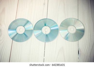 Cds And Dvds On Wooden Background