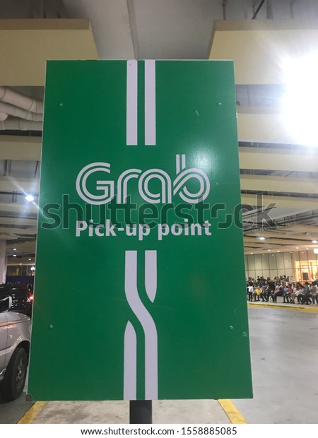 Cebu City, Cebu /\
Philippines - April 07, 2018: Grab taxi ride share hailing app\
pickup point at SM Seaside Cebu shopping mall garage and passenger\
land transportation hub