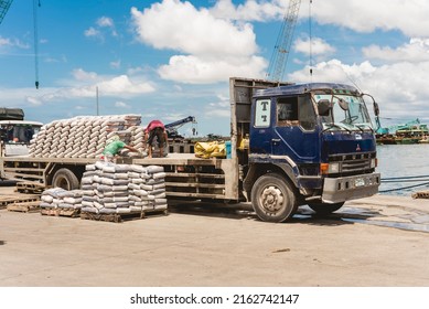 Cebu City, Philippines - May 2022: Workers Load Cement Bags Into An Open Bed Truck To Be Transported Via Ship. At The Port Of Cebu.