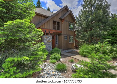 Cedar Brown Mountain Home With Great Landscaping And Rocks, Modern Lines Of The Front Exterior During Summer.