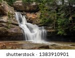 Cedar falls, a beautiful waterfall in the Hocking Hills of Ohio, flows strongly after heavy spring rains.