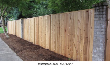 Cedar Fence with Brick accents, privacy fence                          - Shutterstock ID 656717047