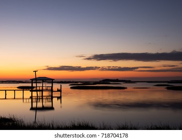 Cedar Key, Florida. Dock with sunset and saw grass.