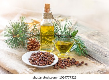Cedar oil. Bottles with cedar oil and pine nuts on the table.