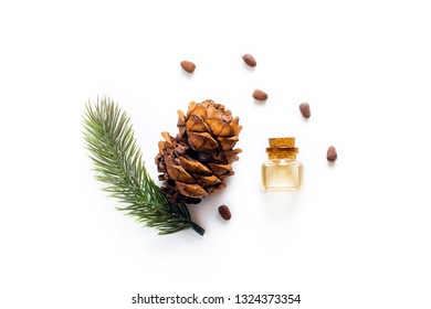 Cedar oil Bottles with pine oil and pine nuts, isolated on a white background