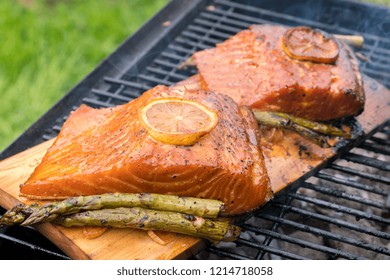 Cedar Plank Salmon With Lemon Cooking On Grill