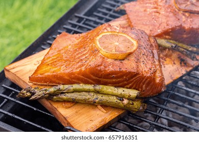 Cedar Plank Salmon With Lemon Cooking On Grill