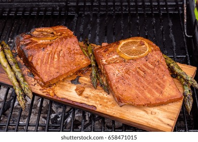 Cedar Plank Salmon With Lemon Cooking On Grill