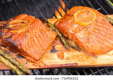 Cedar Plank Salmon With Lemon Cooking On A Grill