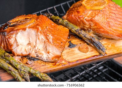 Cedar Plank Salmon With Lemon Cooking On A Grill