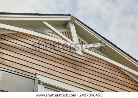Cedar Shake Siding and Gable Struts Against Blue Sky