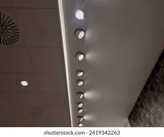 the ceiling of the corridor in the plasterboard soffit is equipped with light halogens illuminating the ramp on the stage or in the shop. the goods look better if there are strong lamps in the ceiling