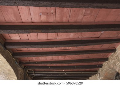 Ceiling With Exposed Wood Beams And Brick Walls