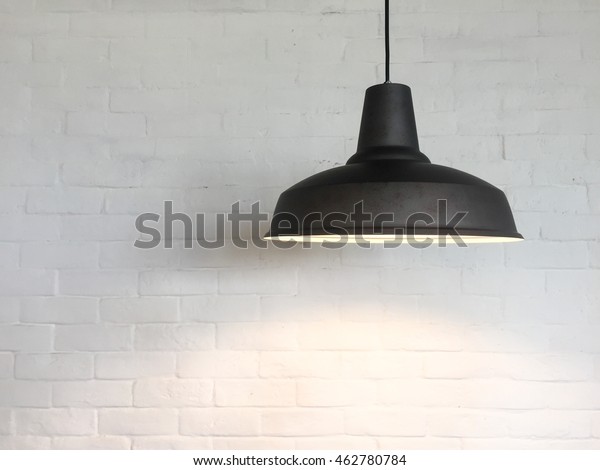 The Ceiling\
Fixture on brick wall\
background.