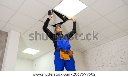 Ceiling installation with expert technicians In the room that is in the construction process.