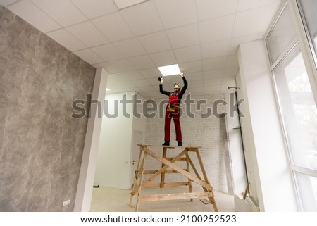 Ceiling installation with expert technicians In the room that is in the construction process.
