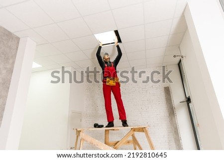 Ceiling installation with expert technicians In the room that is in the construction process.