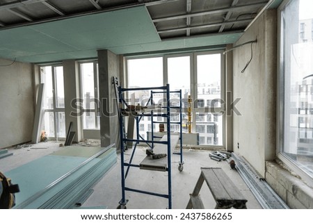 Ceiling installation with expert technicians In the room that is in the construction process.