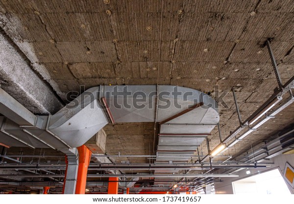 Ceiling\
insulation, ventilation system air ducts, fire extinguishing system\
pipes, electric cable channels under the ceiling of the Parking lot\
on the open ground floor of the\
building
