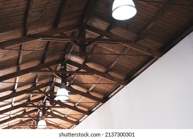 Ceiling lamp lighting decoration in an ancient building interior. Decorative electric lamps hanging on ceiling. White light bulbs in an old historical garage, gar, cafe or shop.  - Powered by Shutterstock