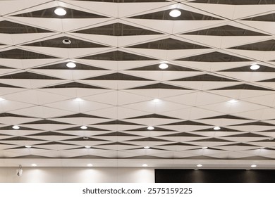 Ceiling with light bulbs lighting with ventilation pipes in airport station in China. Important component of house that enhances beauty. Most popular ceiling panels today. Modern architecture design.