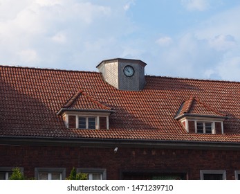 The ceiling of old building with a clock on top and 2 attics 