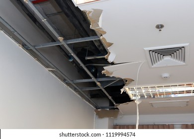 Ceiling Panels Damaged Hole In The Roof Of House From Drain Pipes Water Leakage. House Or Office Building Problem From Plumber System. Service And Repair Concept.