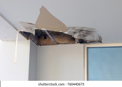 Ceiling panels damaged hole in the roof office from drain pipes water leakage. Office building or house problem from plumber system.