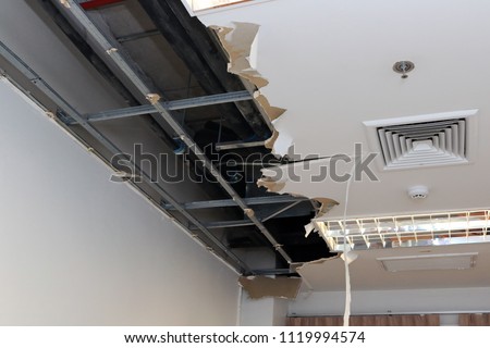 Ceiling panels damaged hole in the roof of house from drain pipes water leakage. House or office building problem from plumber system. Service and repair concept.