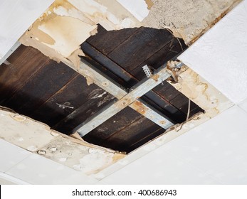 Ceiling panels damaged  huge hole in roof from rainwater leakage.Water damaged ceiling .