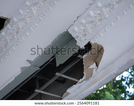 Ceiling panels damaged a large hole in the roof from rainwater leakage. Service and repair concept.