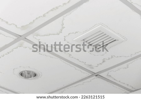Ceiling panels with water stain in house from water pipes damaged or rainy leaked. Office building or house problem for house cleaner service .