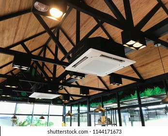 Ceiling type 4 directions air conditioning hanging in a bright glass windows coffee shop