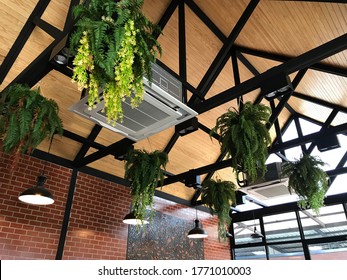 Ceiling type 4 directions air conditioner  venting system unit in a modern coffeeshop with ambience lighting