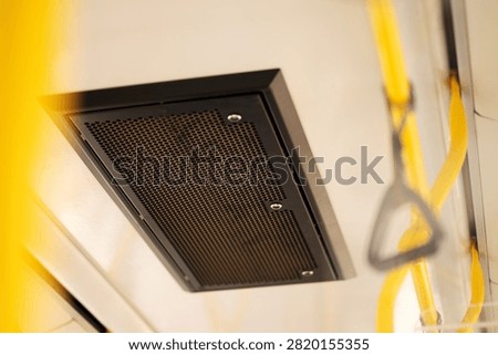 Ceiling ventilation grille and air vent inside public transport interior. Air conditioning system and airflow equipment in city bus, train, or tram.