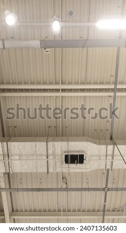 ceiling with wires, pipes and other communications in the mall
