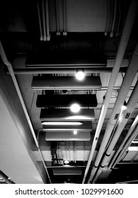 Ceiling without ceiling cap. Showing architectural struture such as beam, lightings, pipelines. Developed in monochrome.