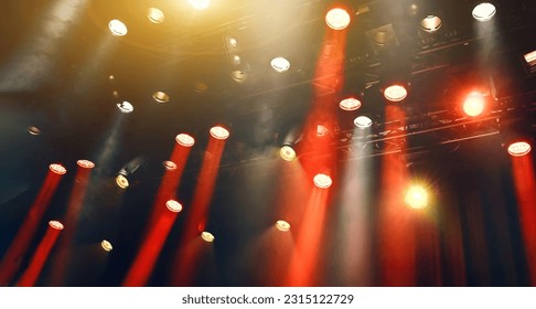 ceiling yellow and red spotlights lights through the Mist on a stage during the musical show - Shutterstock ID 2315122729