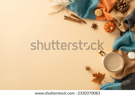 Celebrate beauty of autumn with enchanting arrangement: top view capturing cup of fragrant coffee, snug plaid, petite pumpkins, leaf, pine cone, cinnamon, anise on beige surface. Maximize ad potential