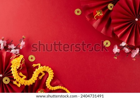 Celebrate Chinese New Year 2024 in an awe-inspiring style. Top view flat lay of gold dragon, red paper fans, gold coins, sakura bloom on red background with promo area