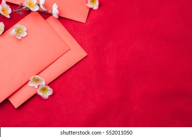 celebrate Chinese New Year background with red envelope and beautiful blossom.