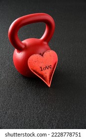 Celebrate Valentine’s day with fitness, red metal heart with the word love against a red iron kettlebell
 - Shutterstock ID 2228778751