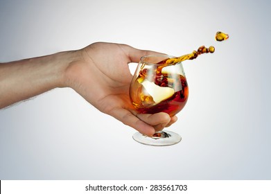 Celebrate The Holiday Background - Hand With Cognac Making Toast - Wonderful Splash